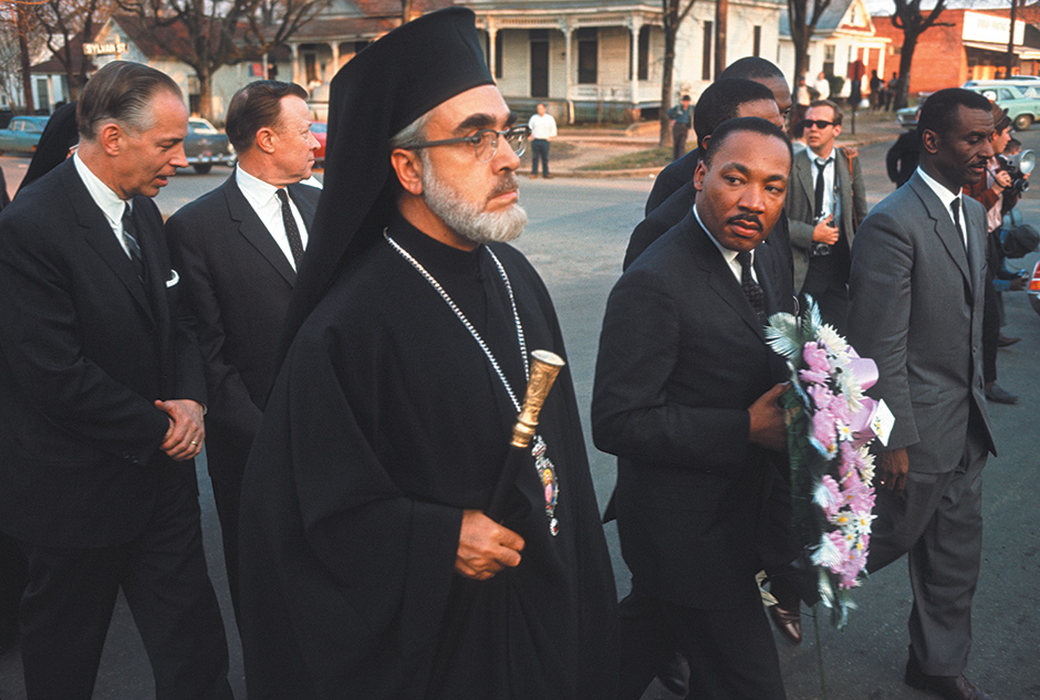 Archbishop Iakovos, Martin Luther King Jr., and other dignitaries walking to the Dallas County Courthouse to hang a funeral wreath in honor of Reverend James Reeb, a civil rights activist who was beaten and killed by white segregationists, Selma, Alabama, March 1965; photograph by Dan Budnik from his book Marching to the Freedom Dream, which includes an essay by Harry Belafonte and has just been published by Trolley
